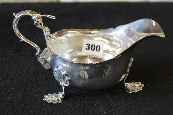 Silver sauceboat with scrolled handle and acanthus feet